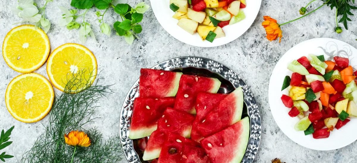 A colorful array of fresh fruit salad with watermelon and citrus, top view.