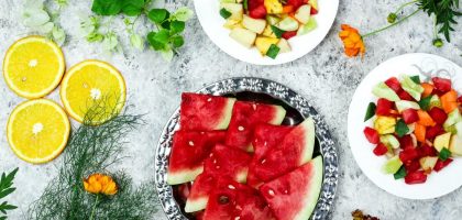 A colorful array of fresh fruit salad with watermelon and citrus, top view.
