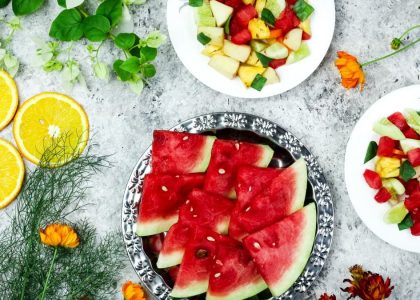 A colorful array of fresh fruit salad with watermelon and citrus, top view.